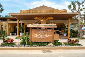 a building with a sign in front of it at Chaykha Retreat Phuket in Chalong