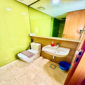 a bathroom with a toilet and a sink and a mirror at Sky klcc by DMK luxury suites Apartment in Kuala Lumpur +47 photos