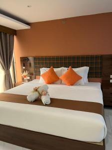 a large bed with two stuffed animals sitting on it at 88th Avenue in Cebu City