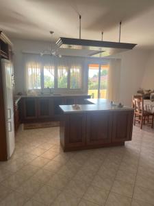 a large kitchen with a island in the middle at MOURTERI TASOSEVa in Mourteri +11 photos