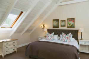 a bedroom with a bed and a window at Auberge Clermont in Franschhoek +95 photos