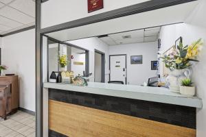 a reception desk in a dental office with flowers at Lillooet Hotel Victoria in Lillooet