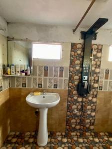 a bathroom with a sink and a cell phone at Fly-In Stay Katunayake in Katunayaka