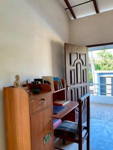 a room with a desk and a chair next to a door at Fly-In Stay Katunayake in Katunayaka +13 photos