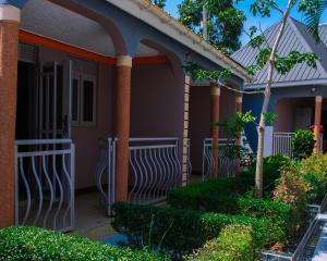 a front porch of a house with a fence at Meltonia Luxury Inn in Busia