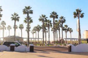 a parking lot with palm trees and a car at Sand Castle in Imperial Beach +112 photos