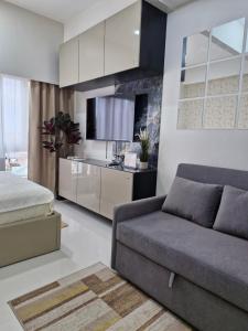 a living room with a couch and a kitchen at WeStay by KM Staycations in Dagupan