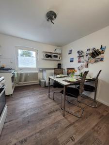 a kitchen and dining room with a table and chairs at ZwischenWasser in Jübek