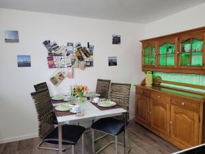 a dining room with a table with two chairs at ZwischenWasser in Jübek