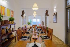a dining room with a long table and chairs at Eklektik in Colombo