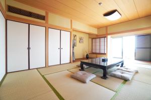 a living room with a table and some windows at Suma Beach House Ref in Takatorichō +98 photos