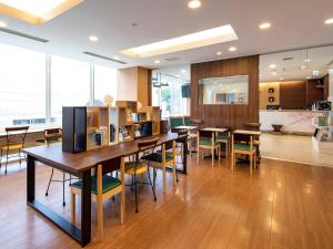 a dining room with tables and chairs in a building at Comfort Hotel Akita in Akita