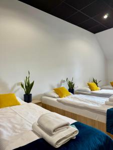 two beds in a room with towels on them at Podhalanin noclegi in Wadowice