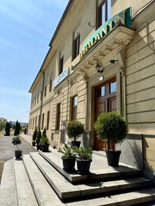 a building with potted plants in front of it at Podhalanin noclegi in Wadowice