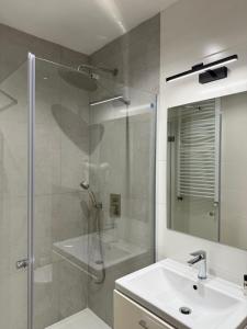 a bathroom with a shower and a sink and a mirror at Podhalanin noclegi in Wadowice +18 photos