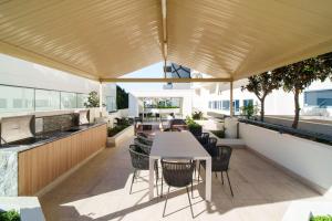 an outdoor patio with a table and chairs at Dockside Brisbane in Brisbane