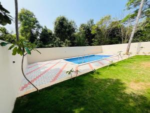a swimming pool in the backyard of a house at Villa D Amour in Pondicherry