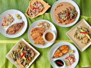 a table with plates of food and a cup of coffee at North Shore Surf Camp in Baler