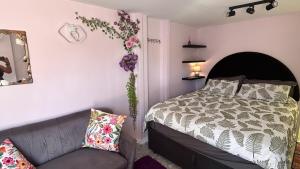 a bedroom with a bed and a couch at Marina Dreams Studio Apartment in Marina Da Gama