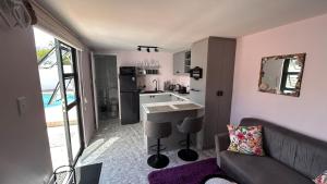 a living room with a couch and a kitchen at Marina Dreams Studio Apartment in Marina Da Gama