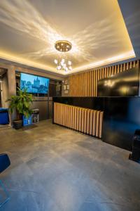 a lobby with a reception desk and a television at Inn City Park Hotel in Burunabat