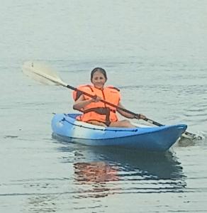 a woman in a kayak on the water at Warram mobile in Puerto Princesa City
