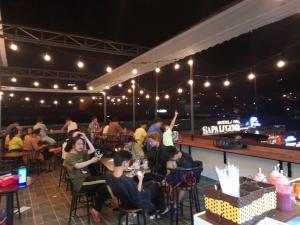a group of people sitting in a restaurant at night at OnTop Hotel in Sapa +3 photos