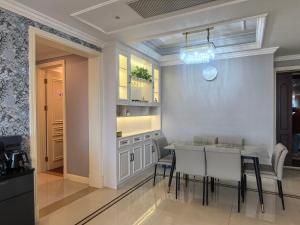 a kitchen with a dining room table and chairs at SeaHear Premier in Rizhao