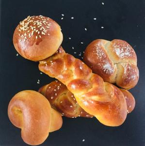 a pile of buns and bagels on a table at Mimi's Cottage in Udawalawe