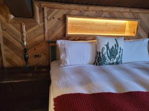 a bedroom with a bed in a wooden cabin at Impression Nordic Manor Club in Ren'ai