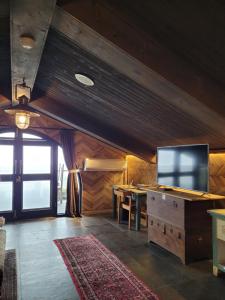 a living room with a television and a table at Impression Nordic Manor Club in Ren'ai