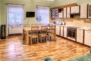 a kitchen with a table and chairs in it at Apartmány pod Divadlem in Znojmo