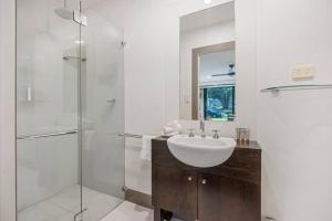 a bathroom with a sink and a glass shower at McLaren Flat Studio in McLaren Flat