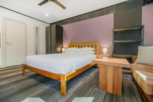 a bedroom with a large bed and a couch at McLaren Flat Studio in McLaren Flat