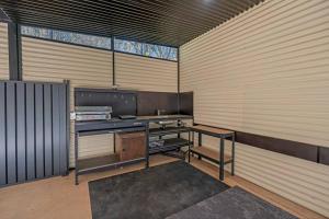 a room with a kitchen in a wooden wall at McLaren Flat Studio in McLaren Flat