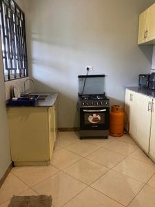 a kitchen with a stove in the corner of a room at Tulivu Nyumba in Arusha