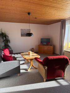 a living room with a couch and a table and chairs at Ferienhaus Tobie in Ahlefeld
