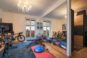 a room with a gym with bikes and a mirror at MountainRelaxKtzh in Kitzbühel