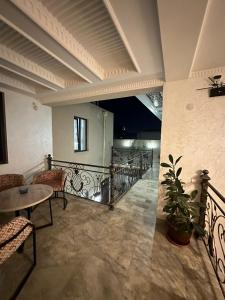 a room with a balcony with a table and chairs at Abu Zarr Terrace in Bukhara