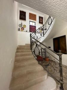 a staircase in a home with a wrought iron railing at Abu Zarr Terrace in Bukhara