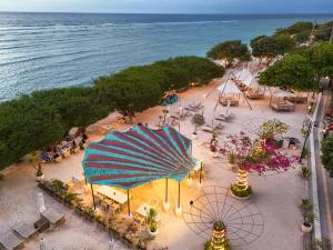 an overhead view of a beach with a blue umbrella at Pearl Sunset Resort - Sunset Moments, Adults Only in Gili Trawangan