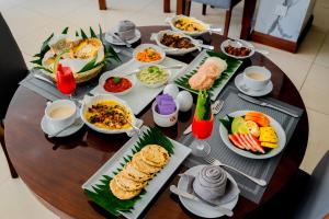 a table with plates of food on it at Lavendish Beach Resort in Unawatuna +48 photos