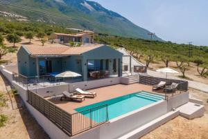 an aerial view of a house with a swimming pool at Villa Katoikia Dio by Villa Plus in Simotáta