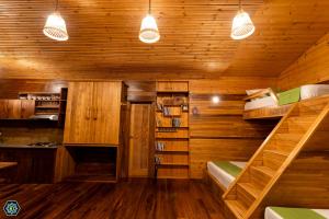 a room with wooden walls and two bunk beds at Hotel Narangala Wooden Villa in Badulla