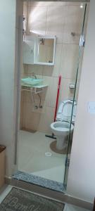 a bathroom with a toilet and a sink at Hotel metrosul Ltda in São Paulo