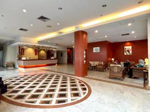 a hotel lobby with a large rug on the floor at Hatyai Golden Crown Hotel in Hat Yai