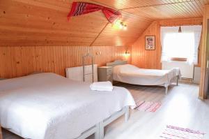 a bedroom with two beds in a wooden cabin at Vila Adela in Lacu Rosu