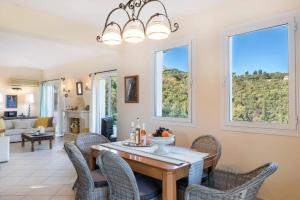 a dining room with a table and chairs at Villa Kalliopi by Villa Plus in Agnítsini