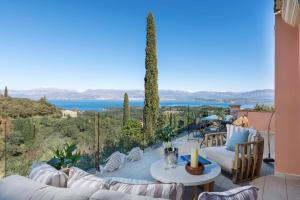 a patio with couches and a table and chairs at Villa Kalliopi by Villa Plus in Agnítsini