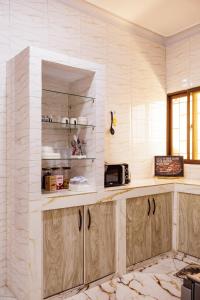 a kitchen with a counter with a microwave at Azara Watamu in Watamu
